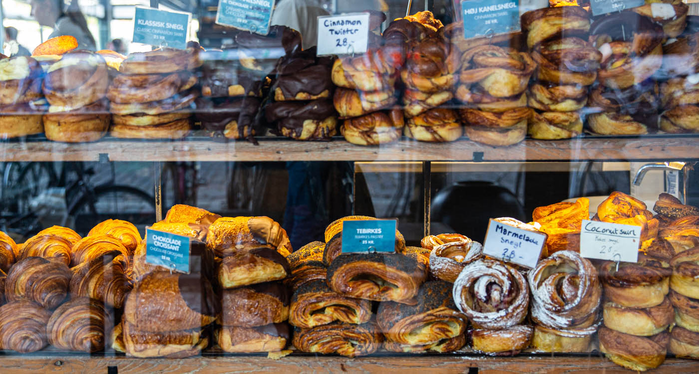 Variety of fresh buns behind the shop window in Torvehallerne indoor market [Photo: Shutterstock]