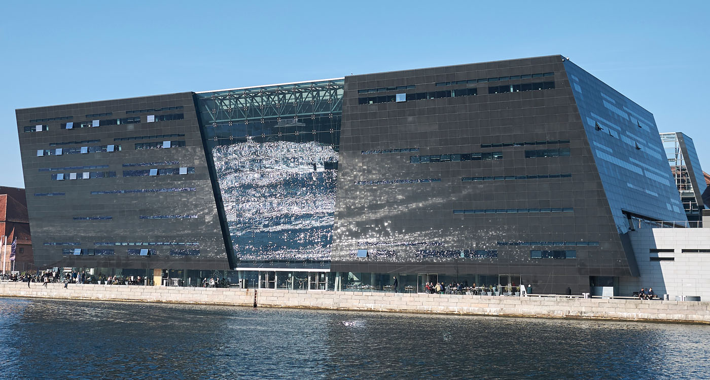 External view of The Royal Library, a modern black boxy construction next to water [Photo: Shutterstock]