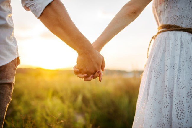 Image of a couple holding hands outdoors