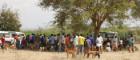A queue of people in rural Tanzania waiting to have their dogs vaccinated against rabies