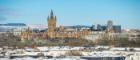 University Main Building, city skyline, snow on hills in the background 