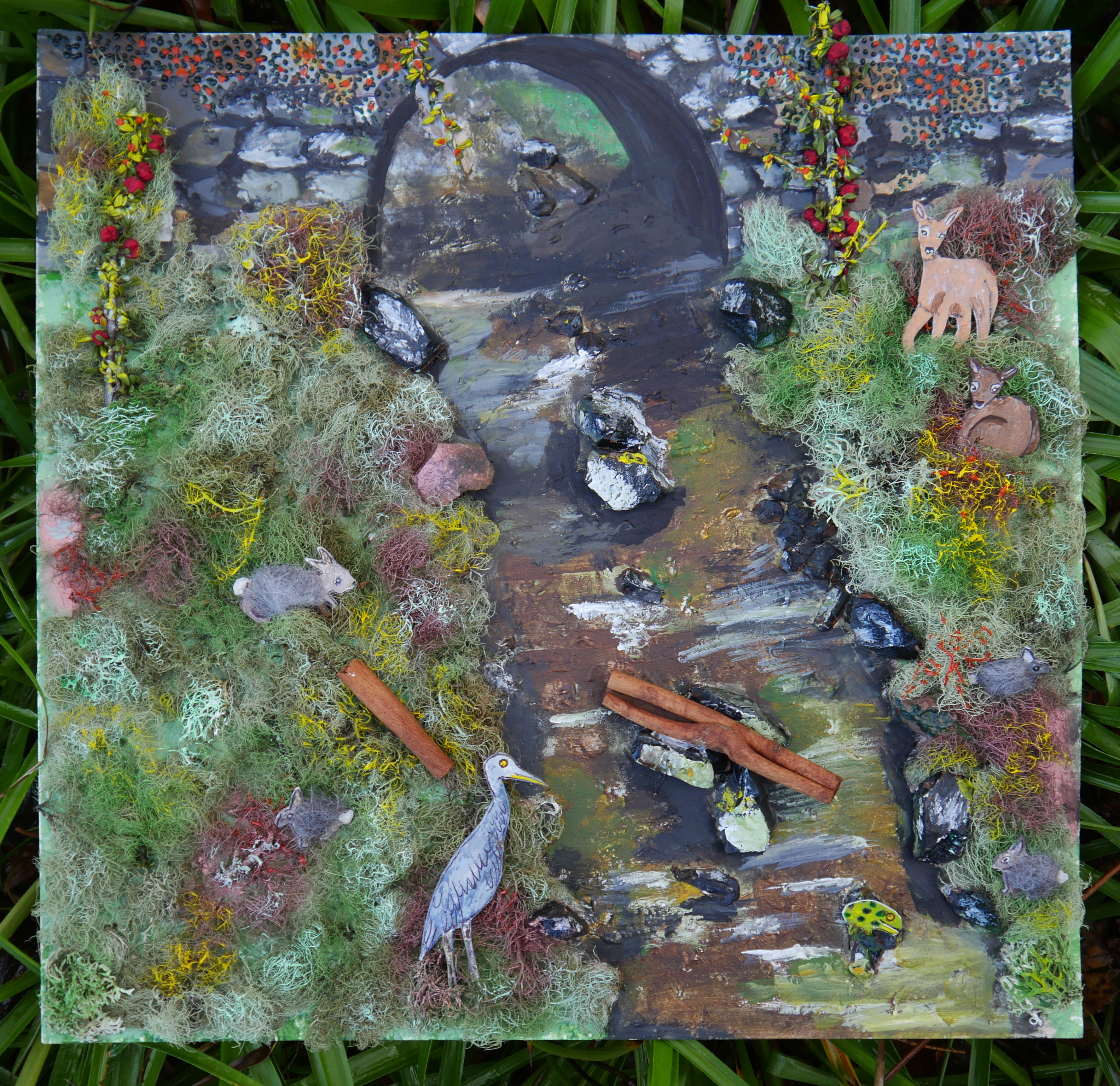 Collage artwork of animals and plants by a river