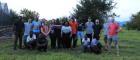 Group photo of people standing and kneeling outside