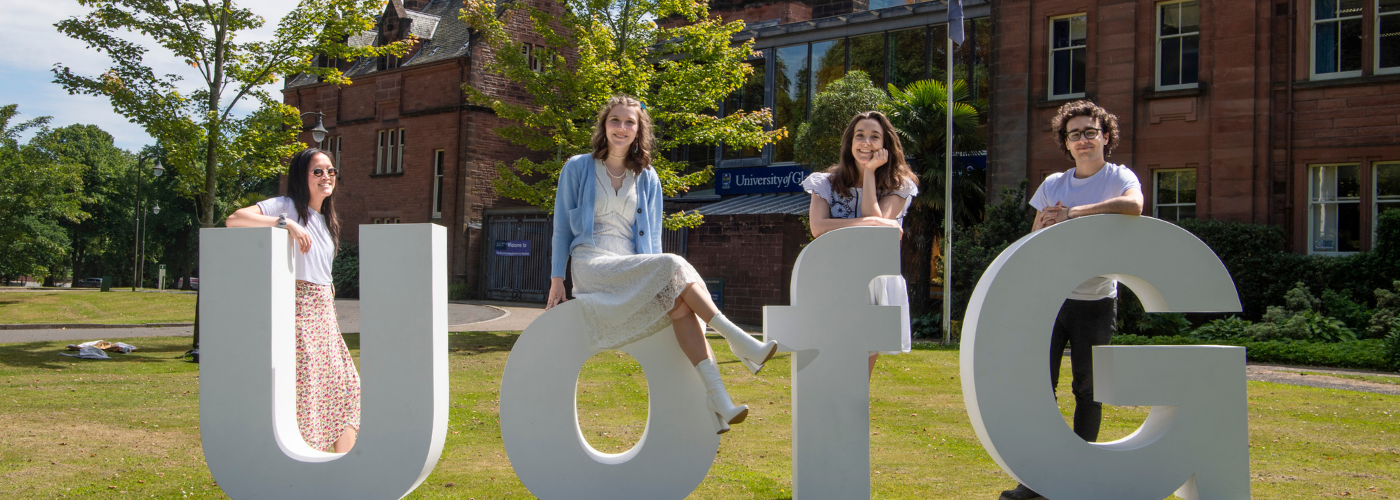 Students standing with large U of G Letters