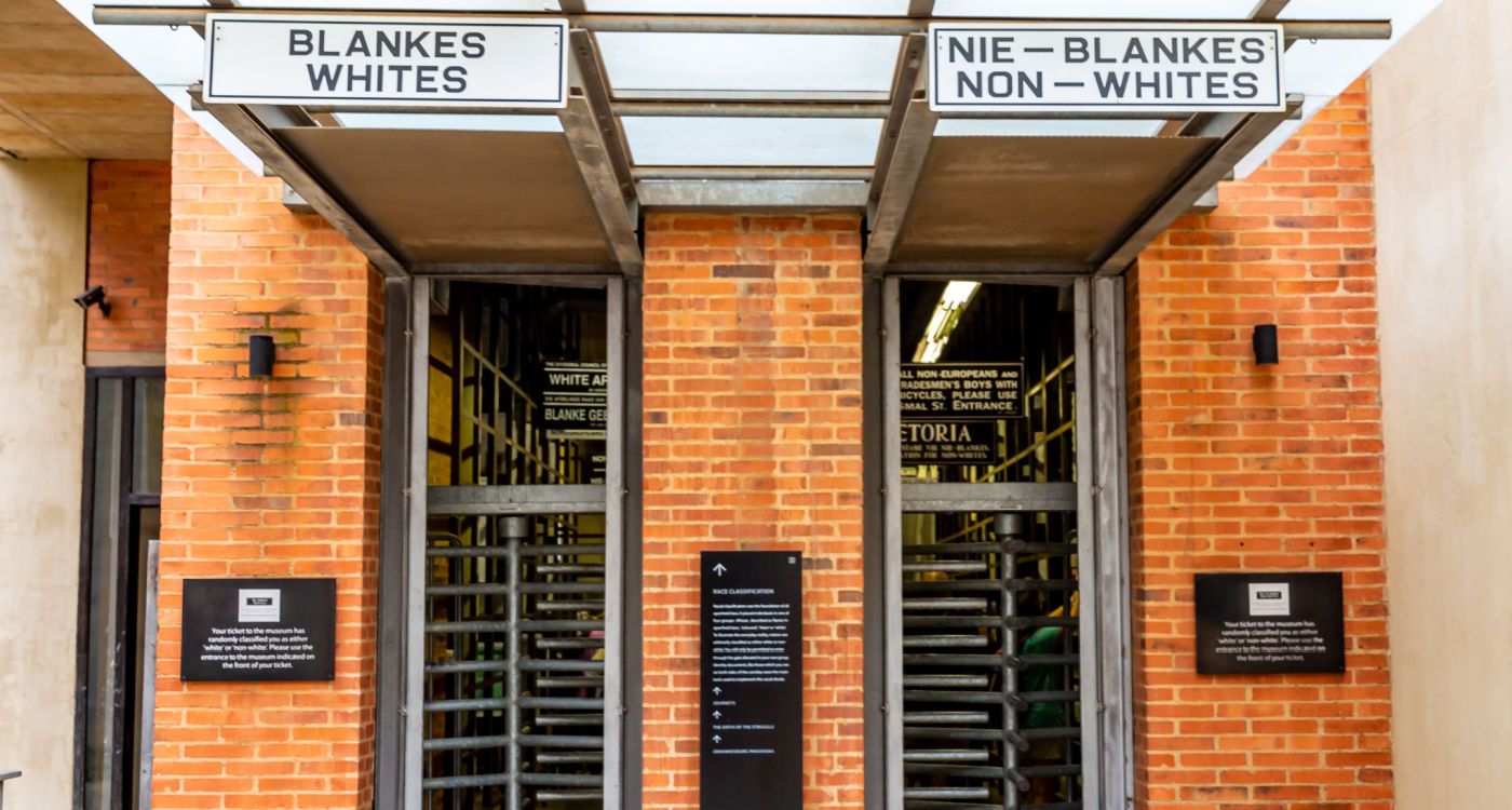 Entrance to the Apartheid Museum, with two doorways: one with a sign above reading ;Whites' and one 'Non-whites' [Photo: Shutterstock]