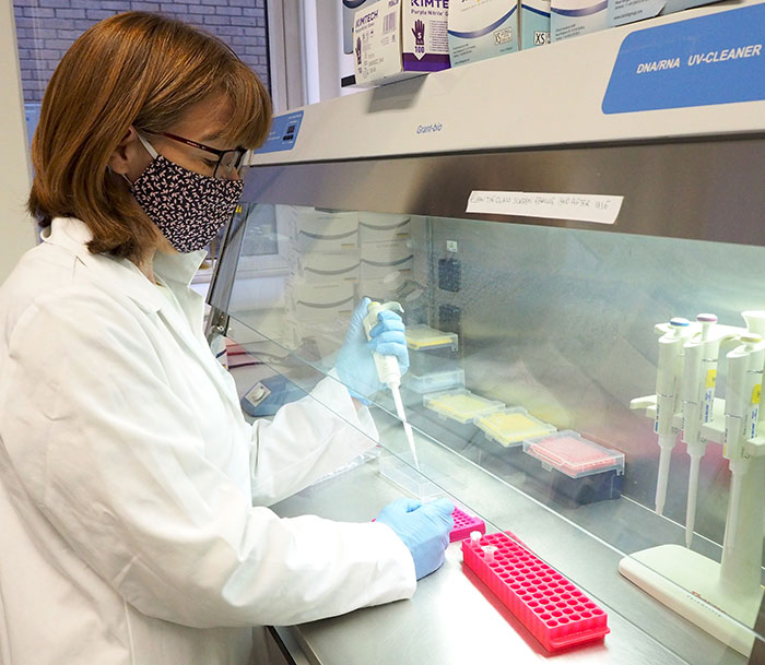 Photo of Julie Russell working at a clean cabinet.