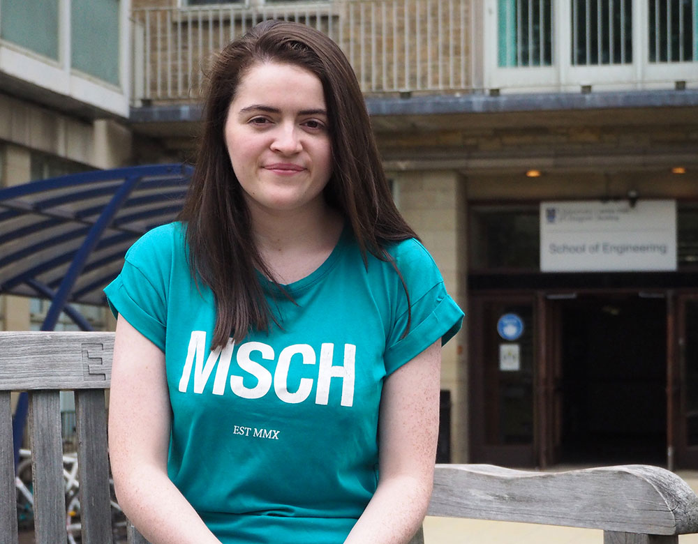 Photo of Rachel Love sitting outside the James Watt South building