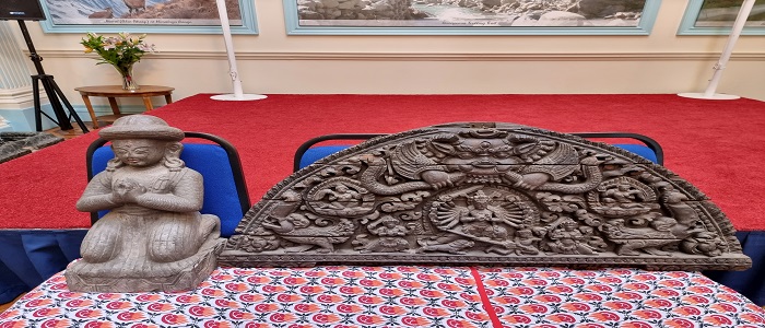 Carved wooden Torana and a carved stone sculpture from Nepal