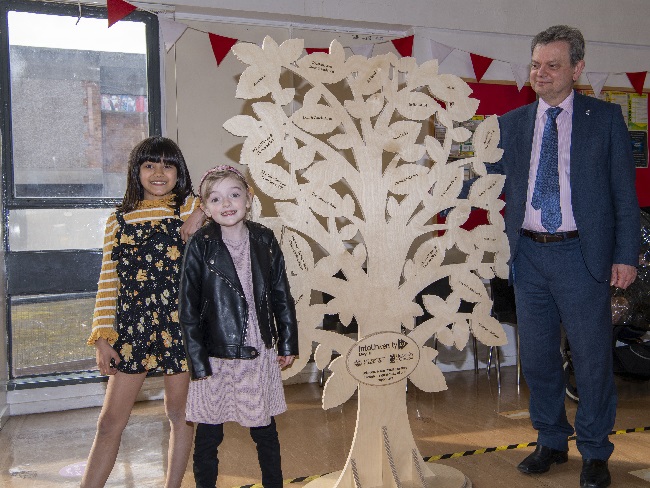 Professor Sir Anton Muscatelli with the IntoUniversity Scotland donor tree with Rosie and Lucy at the launch of IntoUniversity Maryhill