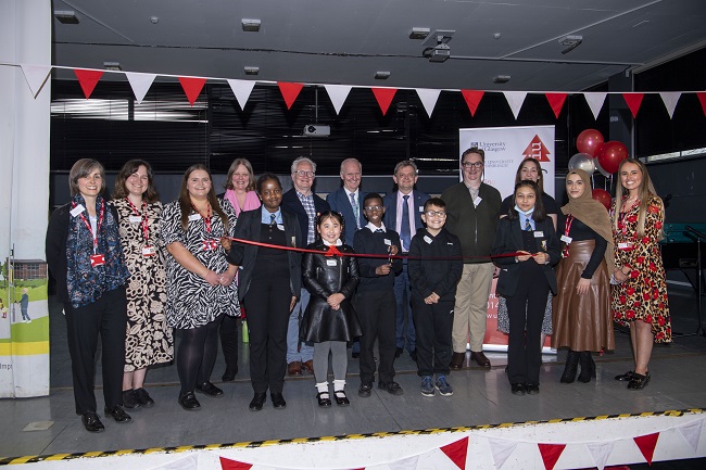 Students and staff of IntoUniversity Maryhill help to cut the ribbon for the official opening ceremony along with Professor Sir Anton Muscatelli of UofG; Professor Colm Harmon, University of Edinburgh and Gerry Lyons of Glasgow City Council 