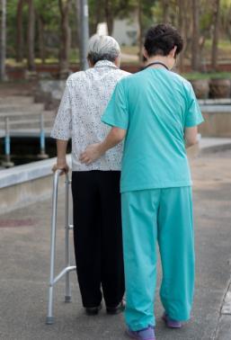 Photo of an old lady walking with a nurse at rehabiliation centre
