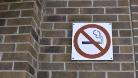 No smoking sign brick wall for news story