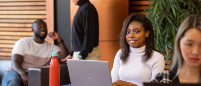 student studying in library on laptop