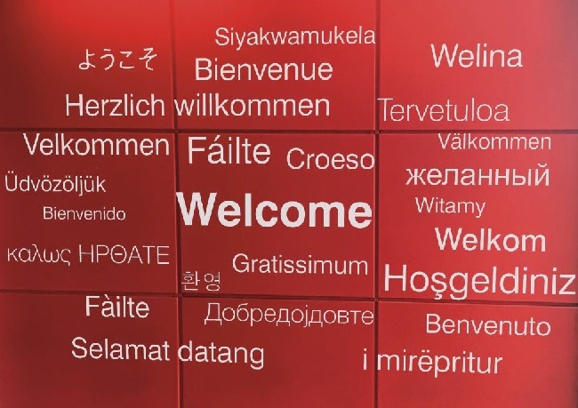 A sign with the word welcome written in many different languages