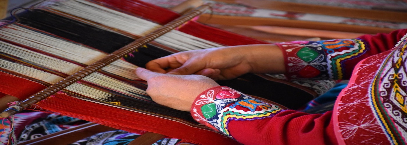 Woman weaving a textile