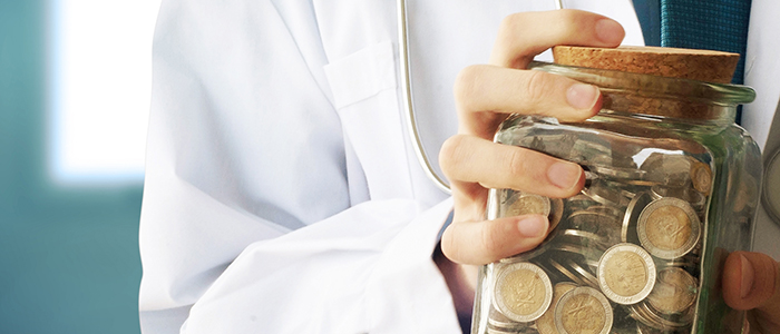 Healthcare worker holding a jar of coins