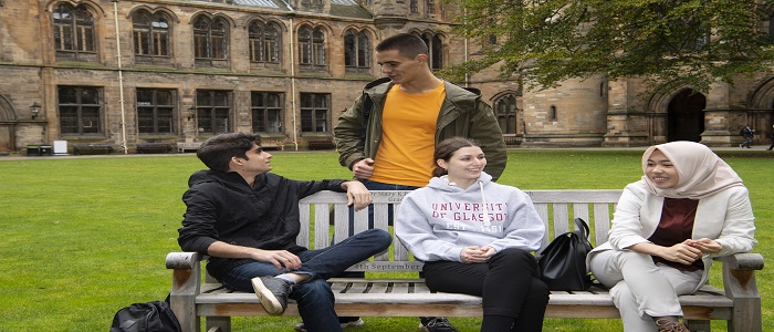 Four young people sitting in the UofG Quads
