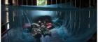 Image of children sleeping in a bed surrounded by mosquito netting
