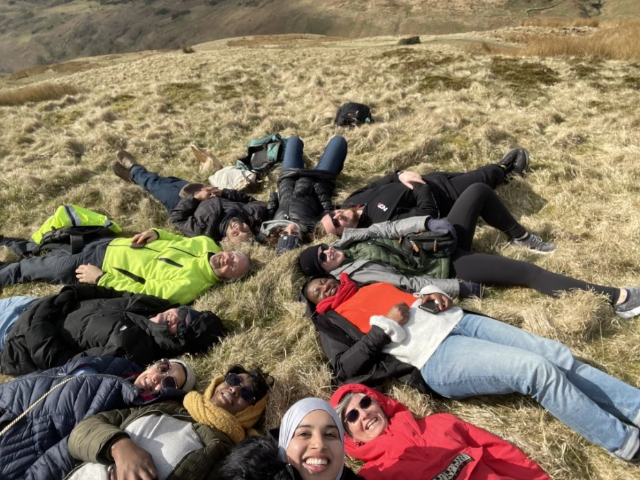 CCSE members lying in a circle, with their heads pointing to the middle, on Campsie Glen