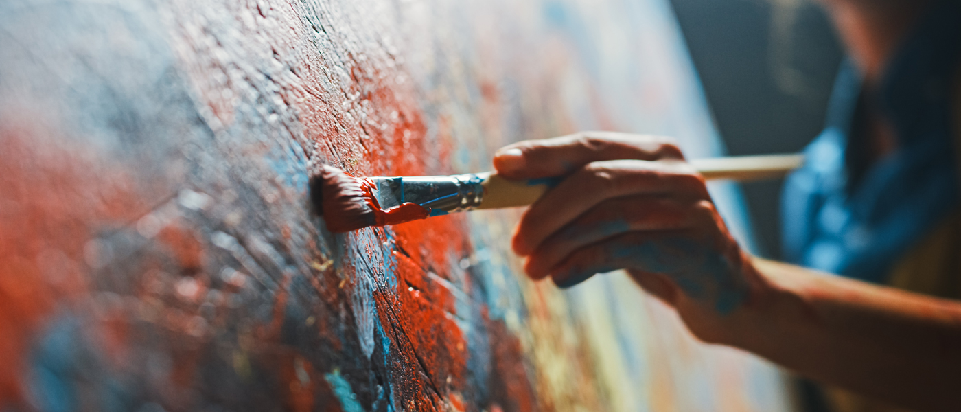 Photo of a person painting on a canvas