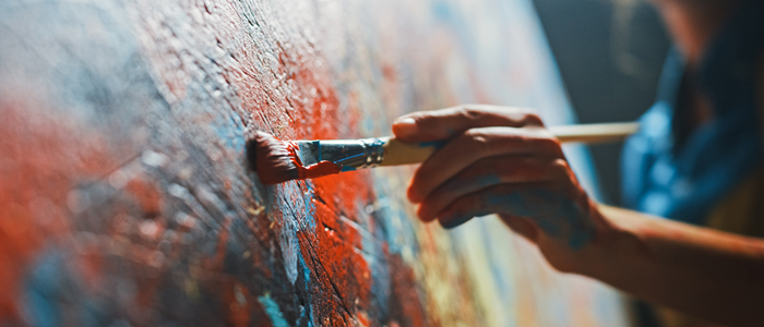 Photo of a person painting on a canvas