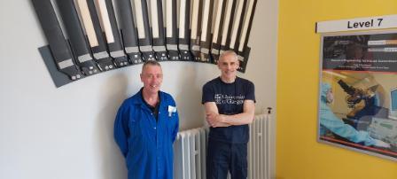 Technicians in front of the model helicopter blades