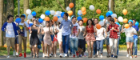 Group of Chinese students at Chengdu with balloons surrounded by trees