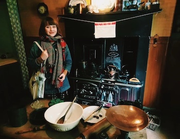 Lindsay Middleton standing in a tenement kitchen
