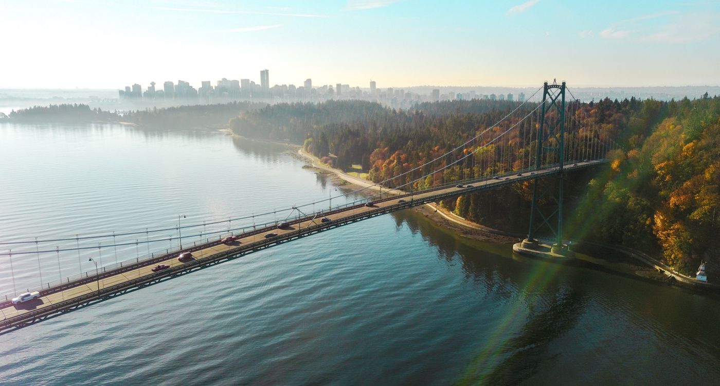 Lions Gate Bridge over water with the city in the background [Photo: Lee Robinson, Unsplash]