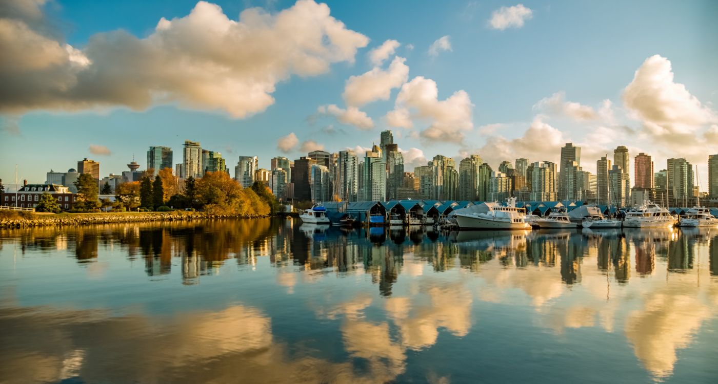 Skyline of Stanley Park Drive in Vancouver with water in the foreground and the sky reflected [Photo: Mike Benna, Unsplash]