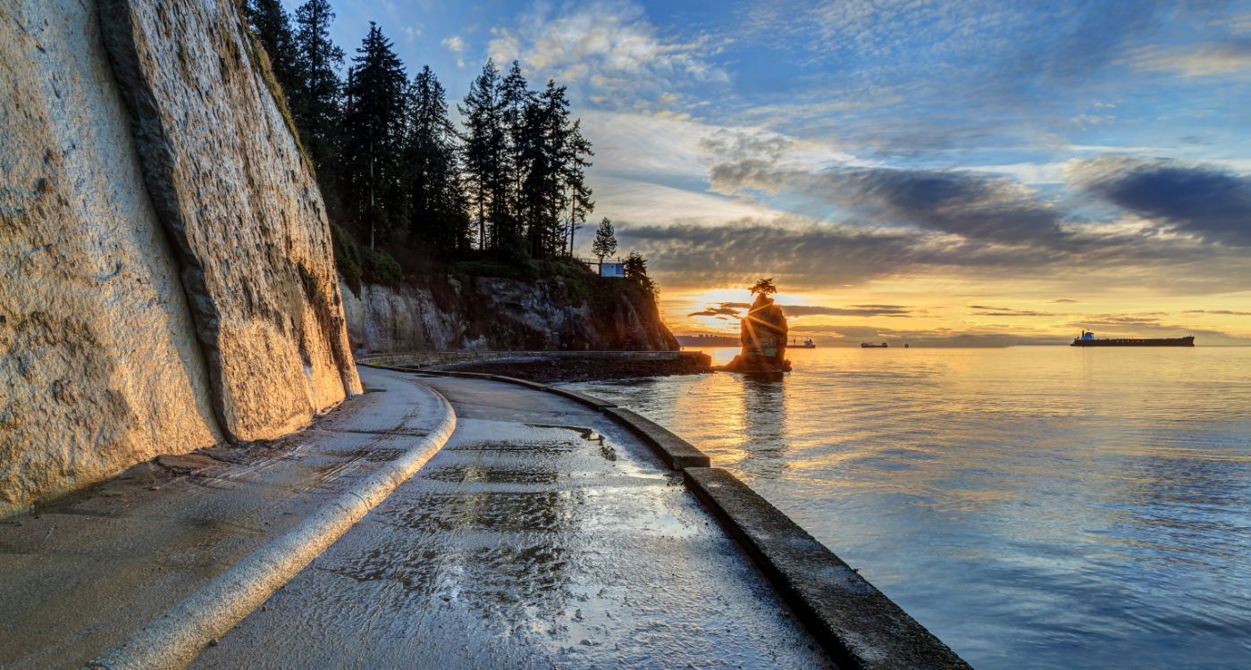 Seawall and rock wall at sunset, with Siwash Rock in the sea water, Stanley Park, Vancouver [Photo: Shutterstock]