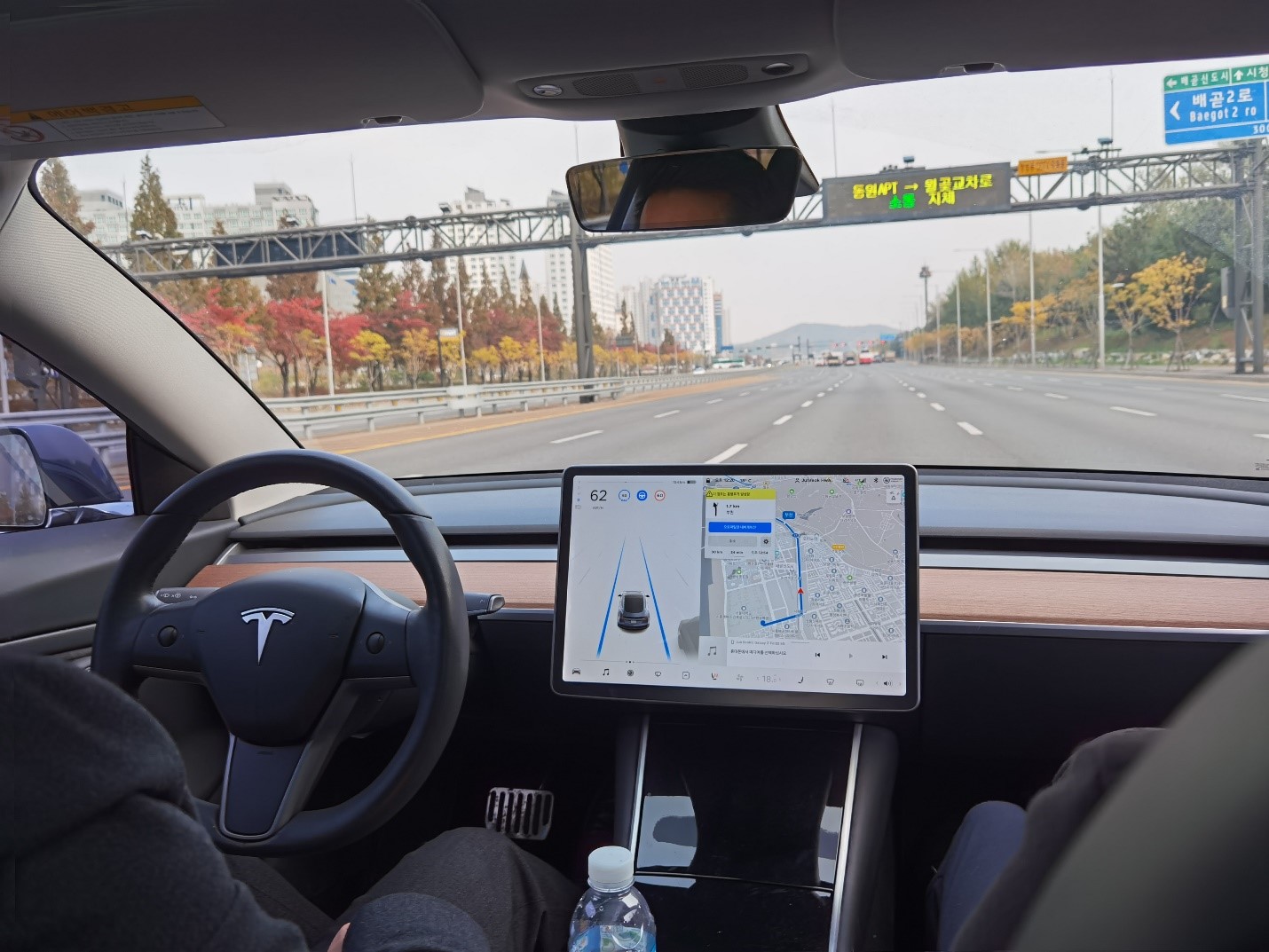 View of a Tesla dashboard as the car drives down a road in Korea