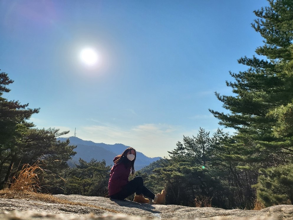 Angela Weihan at the top of Samsung-san hike on a sunny day