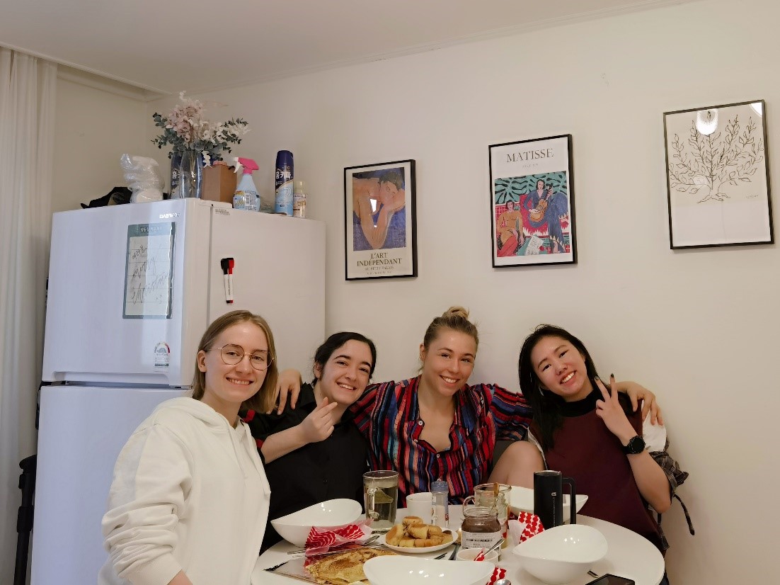 Angela Weihan with three friends sitting at a table for Christmas dinner