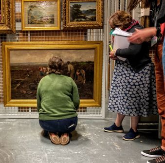 Group of participants taking a closer look at William Stewart MacGeorge, A Galloway Peat Moss, 1888