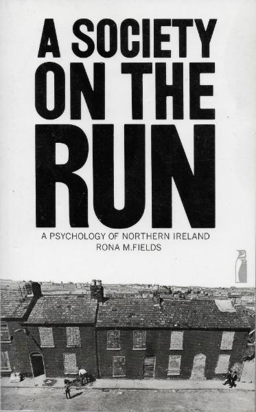 Book cover for A Society on the Run showing black and white photograph of damaged terraced housing. 