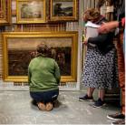 Group of participants taking a closer look at William Stewart MacGeorge, A Galloway Peat Moss, 1888