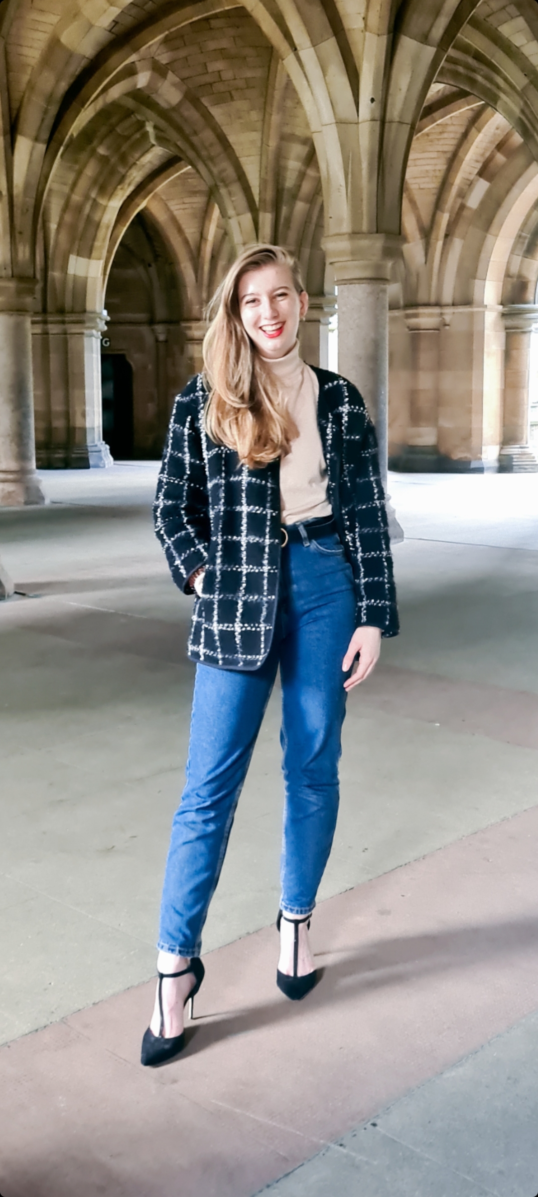 Student standing in U of G Cloisters.