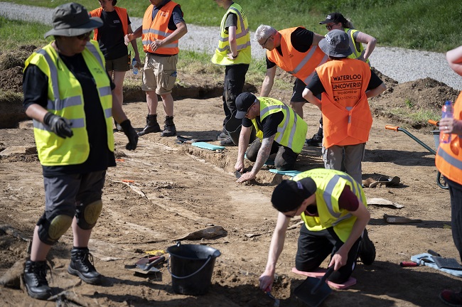 Team members including veterans excavating at Mont-Saint-Jean, Waterloo, Belgium. ©chrisvanhouts