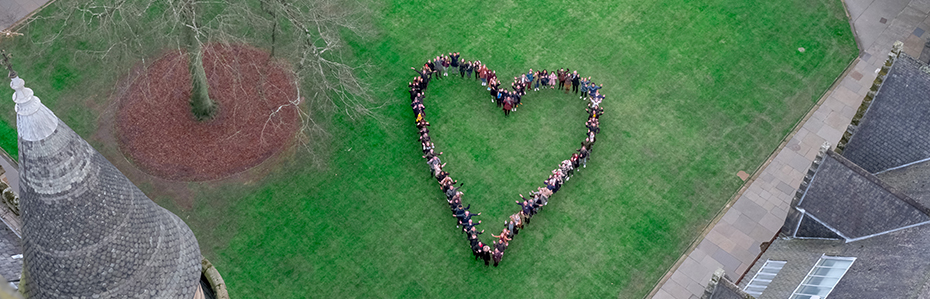 Aerial photo of the East Quadrangle, with students grouped in the shape of a heart.
