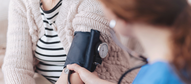 A nurse taking the blood pressure of a patient