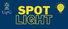 Logo on a dark blue background with a lit lightbulb and the word 'Spotlight' underneath in capitals. 'Spot' is solid yellow whereas 'light' is outlined in yellow. At the top is the Glasgow University crest. 