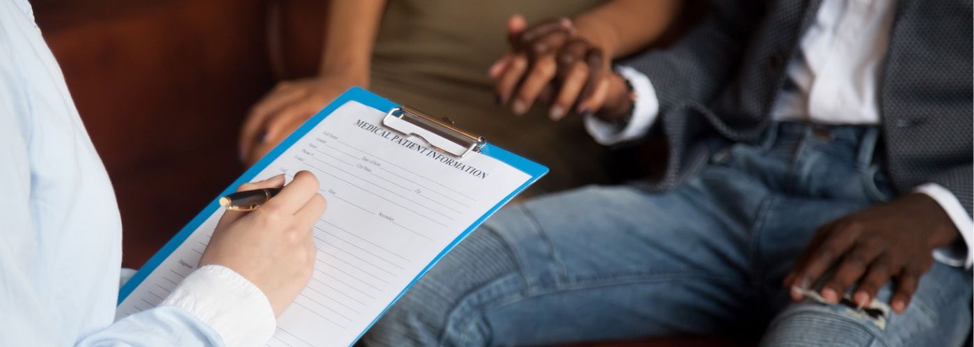 Medical professional consulting with couple