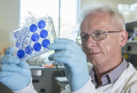 John McLauchlan holding lab equipment 