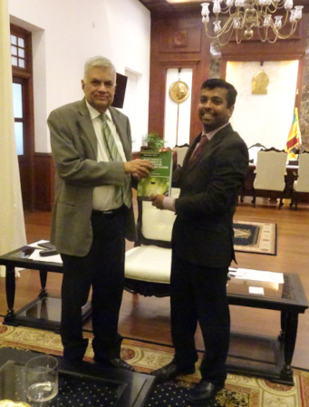 Dr Kelum Gamage shows his book to Sri Lankan President