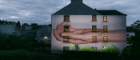 A cupped hand is projected onto the side of a block of flats. Credit Sylwia Kowalczyk