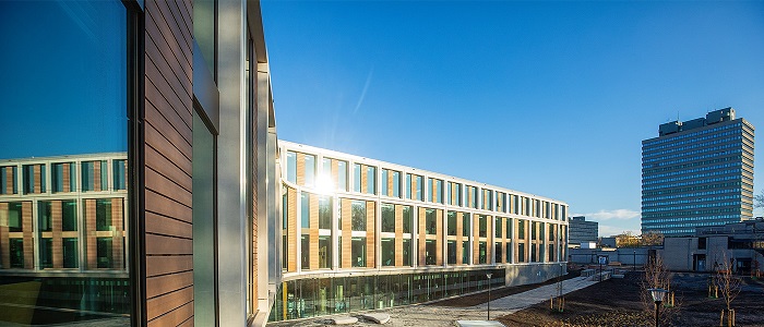 Photo of a modern building - Raboud University gleaming in the sunshine and blue sky