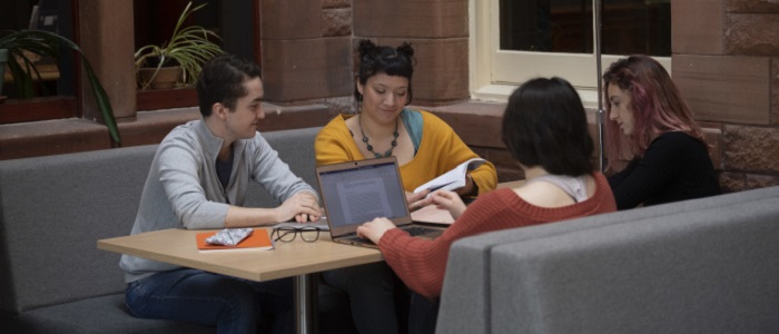 Four people studying around a table with papers, notes and laptops. Source: GU Image Library