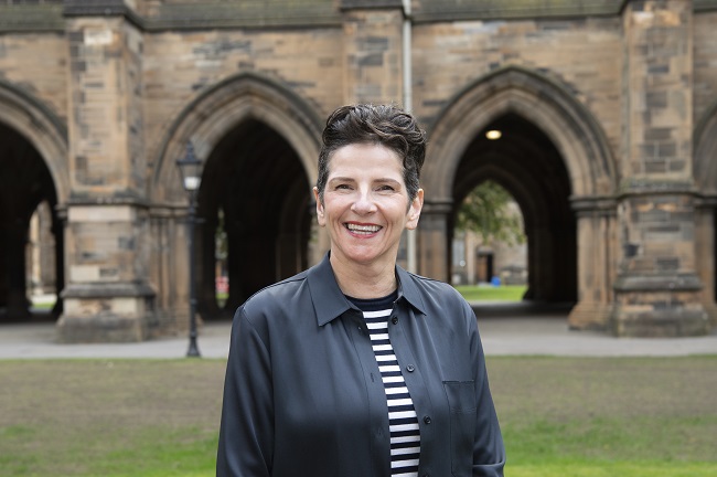 An image of Professor Jenifer Smith in front of the Cloisters 