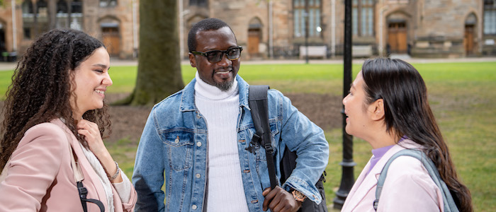 Three students in discussion in the Glasgow University quadrangle. Source: GU Image Library
